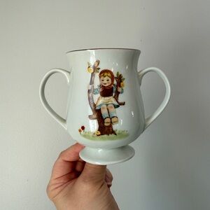 Vintage Two-Handled Porcelain Cup with Girl on Swing Motif - White